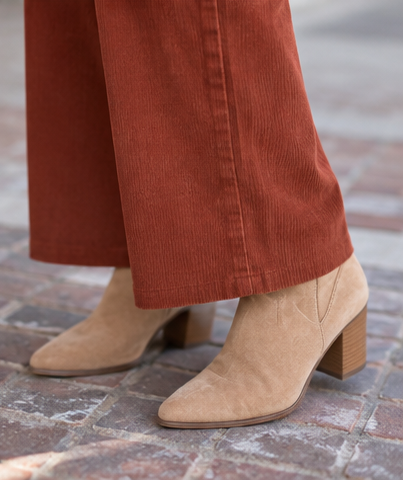 rust umgee corduroy pants on a model wearing a fun colored top