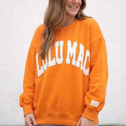 Woman wearing Lulu Mac Tennessee Orange Puff Sweatshirt in bright Tennessee orange with white puff lettering.