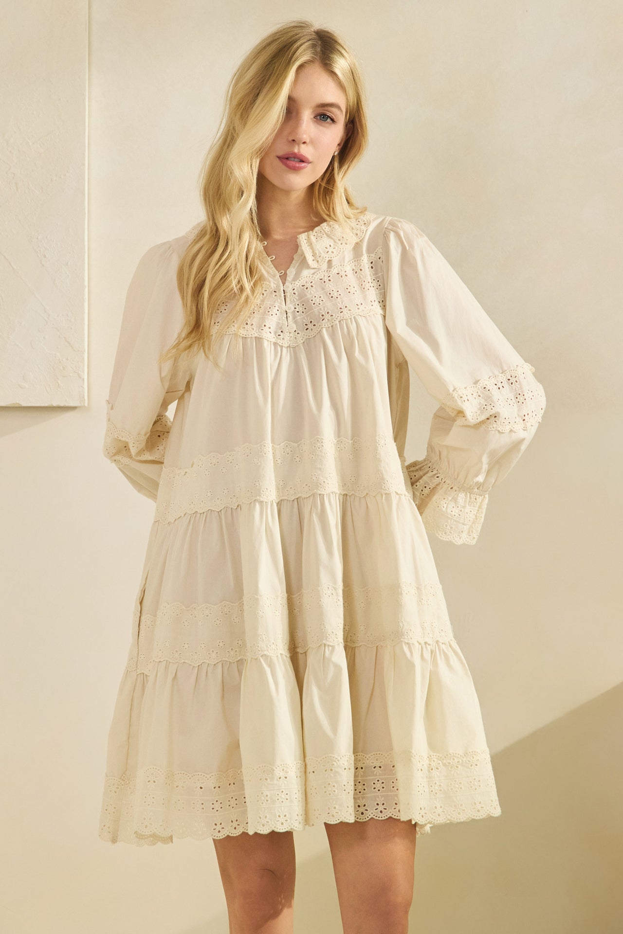 cream babydoll dress side view showing flowy silhouette and lace trim