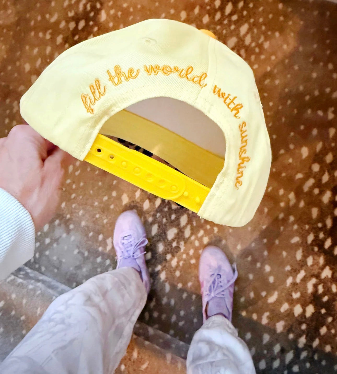 Fill the World with Sunshine Smiley Hat by Poppy and Pine - group of hats flat lay on leopard print fabric