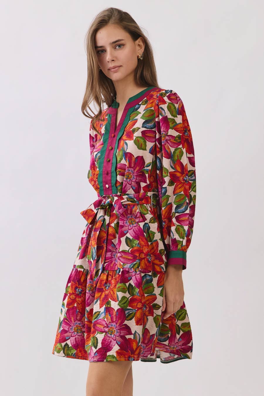 Woman wearing a colorful floral dress on a white background