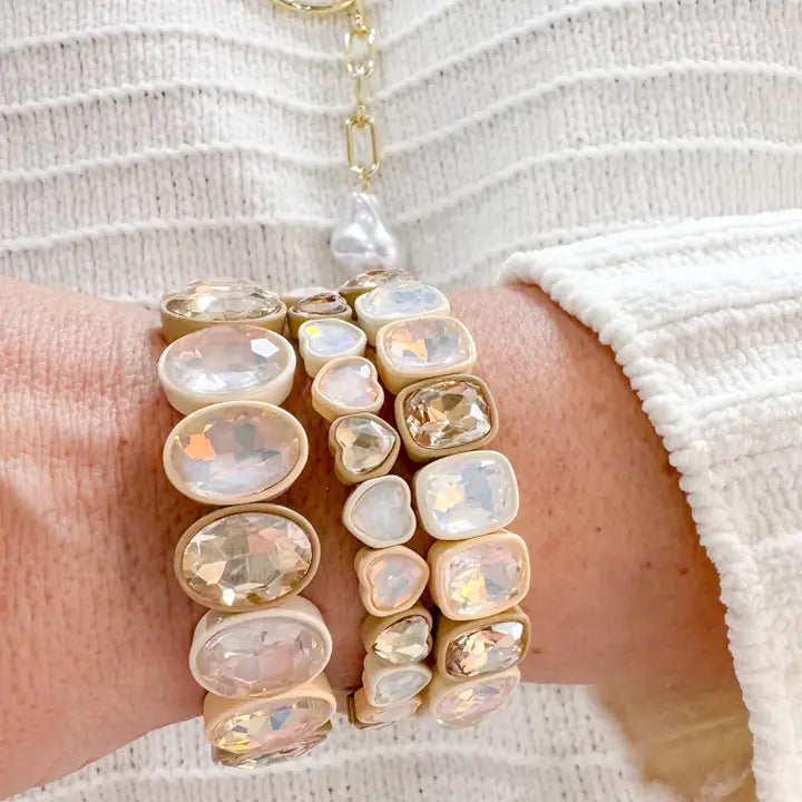 Woman wearing Treasure Jewels Nude Hearts bracelet stack with champagne crystal accents