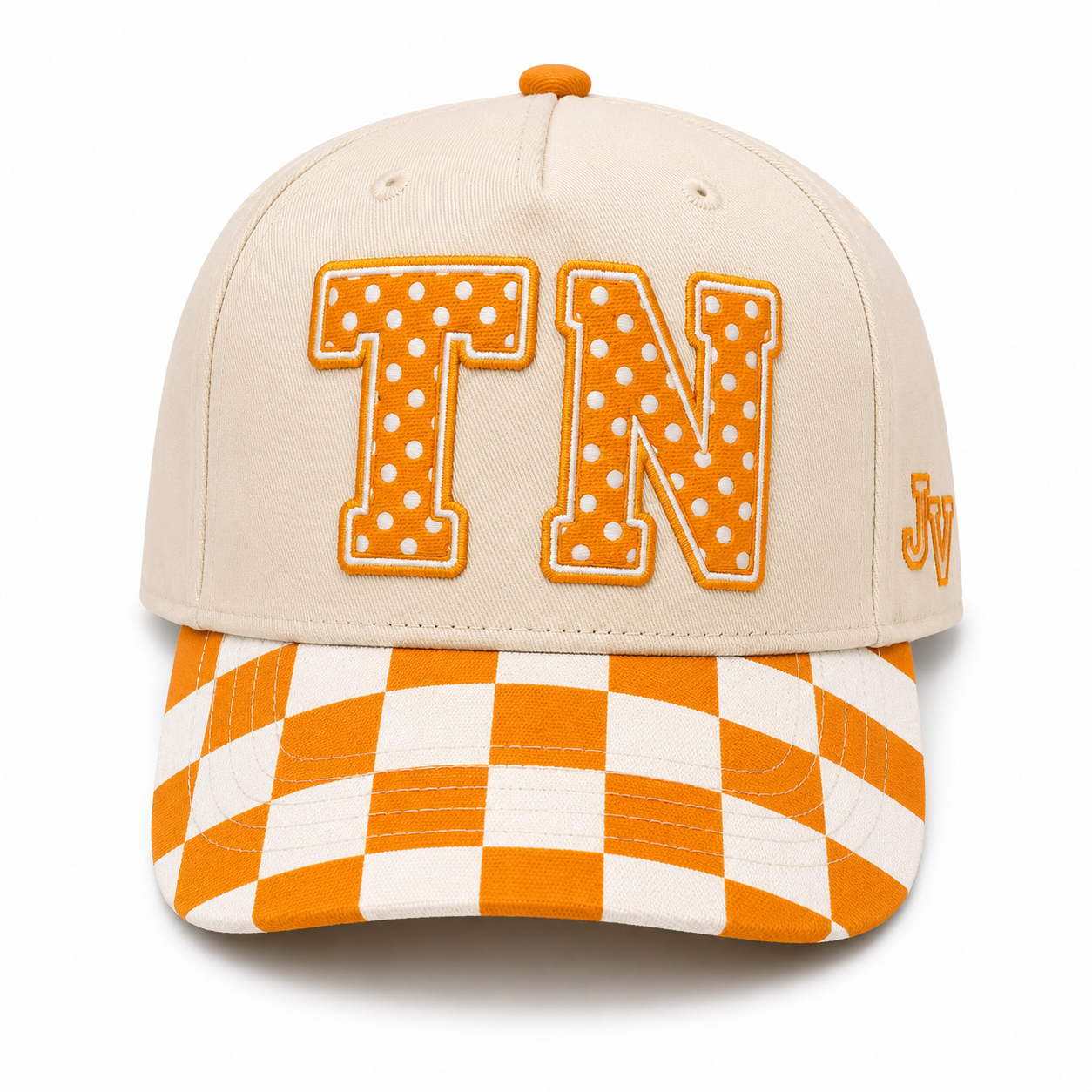 A beige baseball cap featuring large orange and white polka-dotted 'TN' letters on the front, with an orange and white checkered visor and a small orange 'Jv' embroidered on the side.