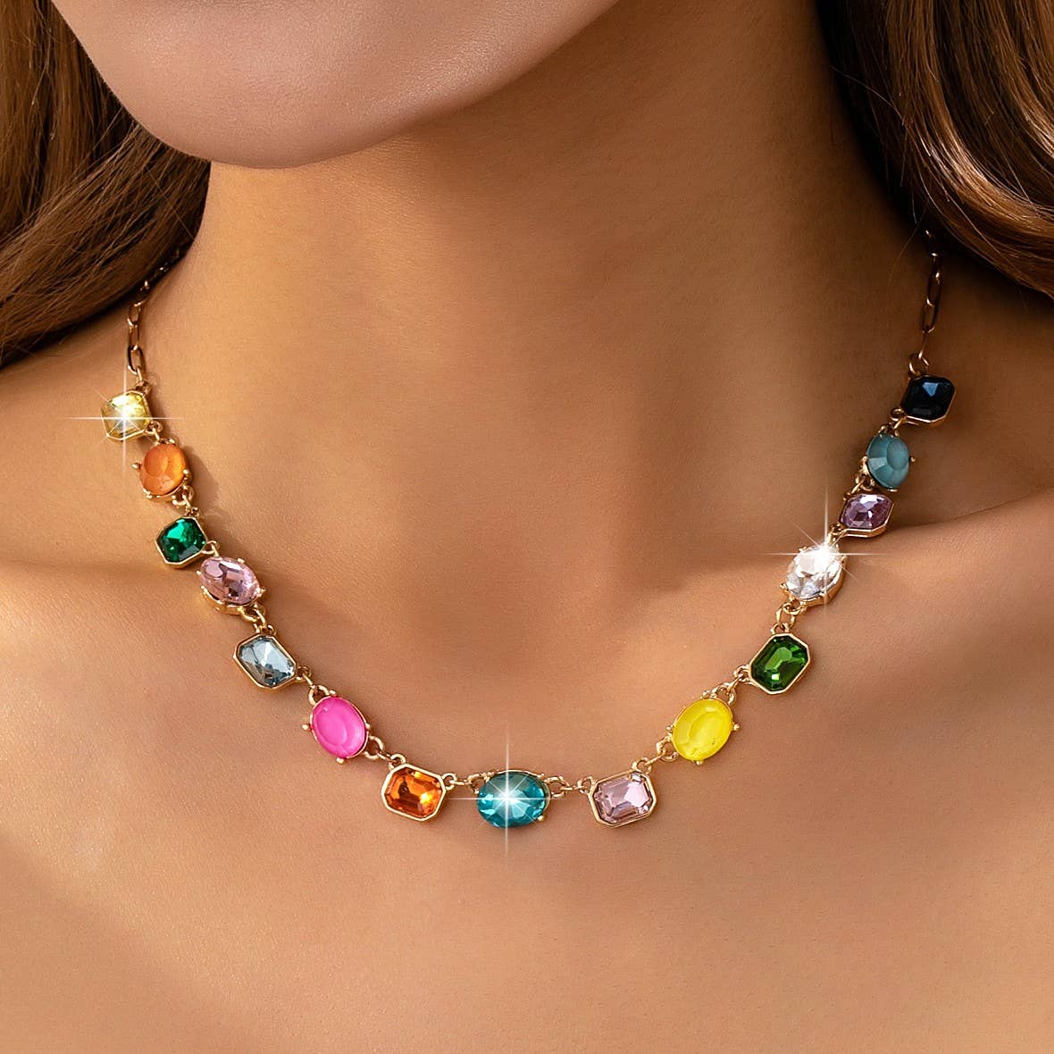 Necklace with multicolored gemstones on a person's neck
