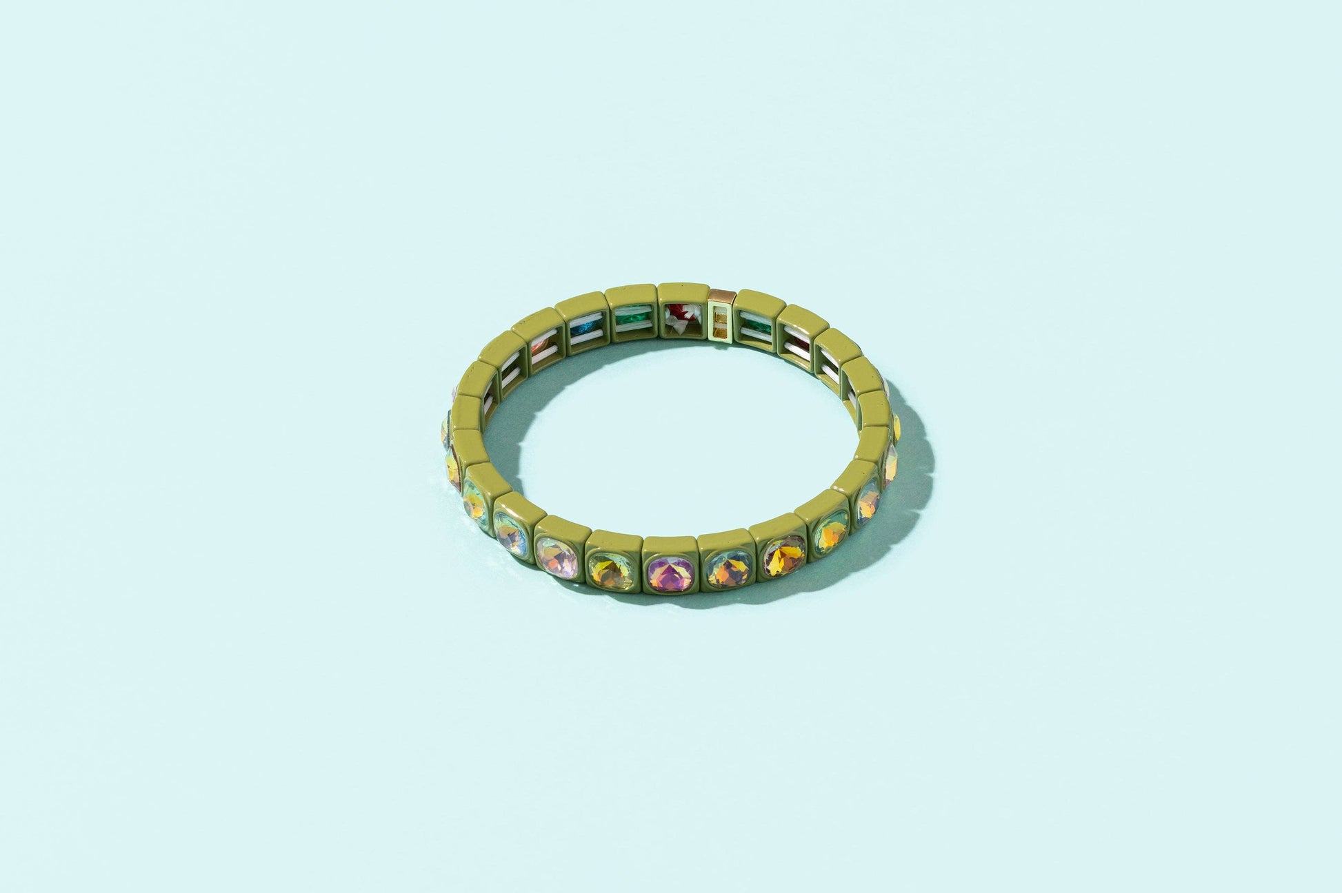 Multicolored gemstone bracelet on a light blue background
