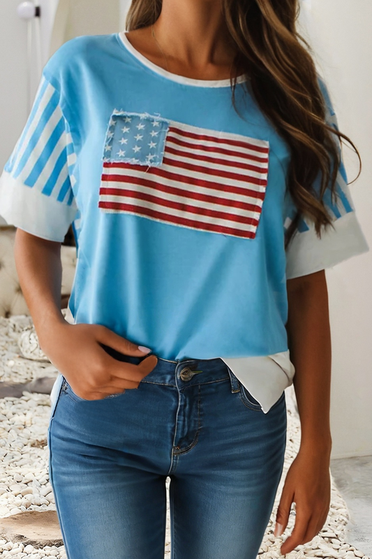 Woman wearing blue patriotic American flag patchwork tee with striped sleeves and denim jeans