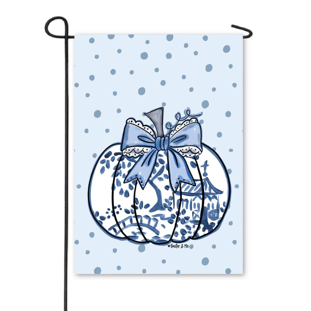 A vertical garden flag on a black metal stand, featuring a light blue background with darker blue polka dots and a central illustration of a white pumpkin decorated with a blue bow and a small pagoda design.
