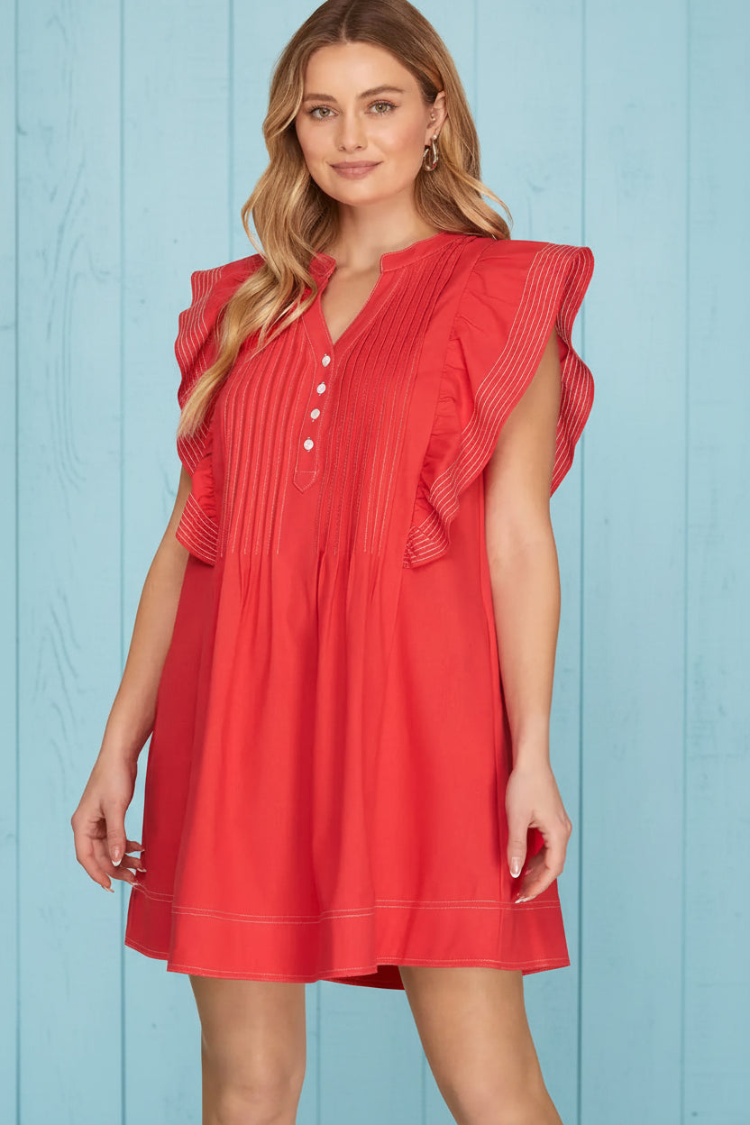 Woman wearing red flutter sleeve mini dress with contrast stitching