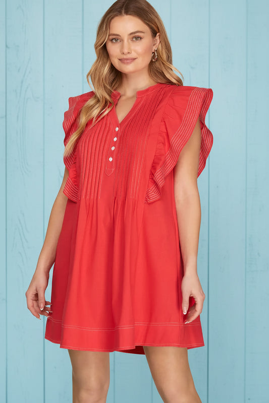 Woman wearing red flutter sleeve mini dress with contrast stitching
