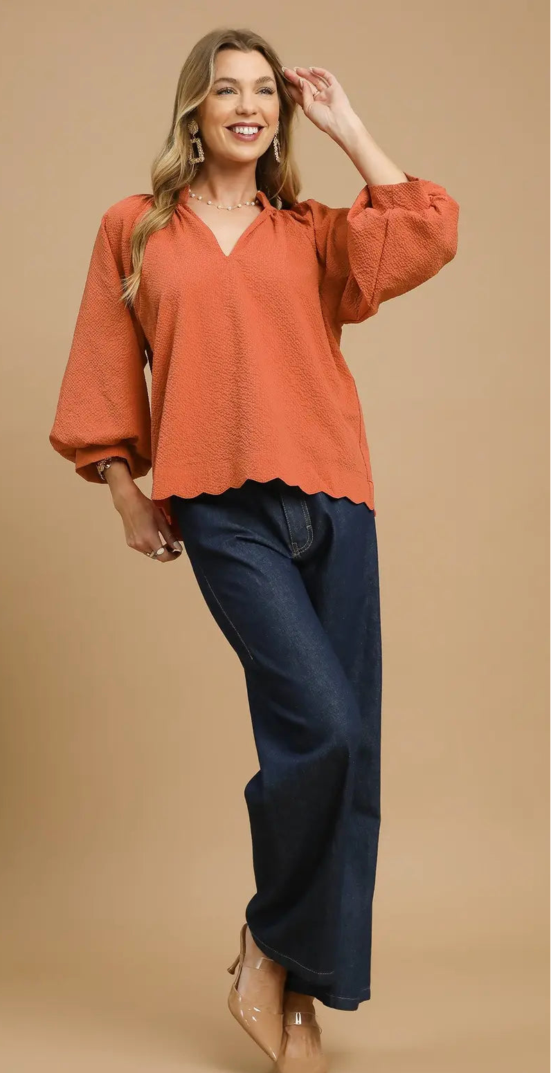 women’s rust flowy blouse with balloon sleeves styled with jeans casual outfit