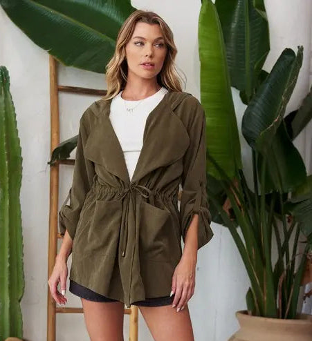 Olive lightweight hooded jacket, front three-quarter view, open over white top and black shorts