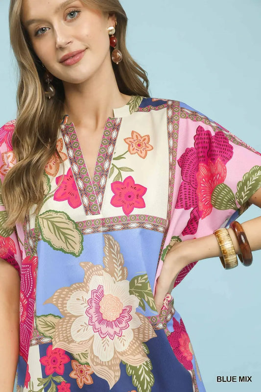 a model wearing a floral top from umgee