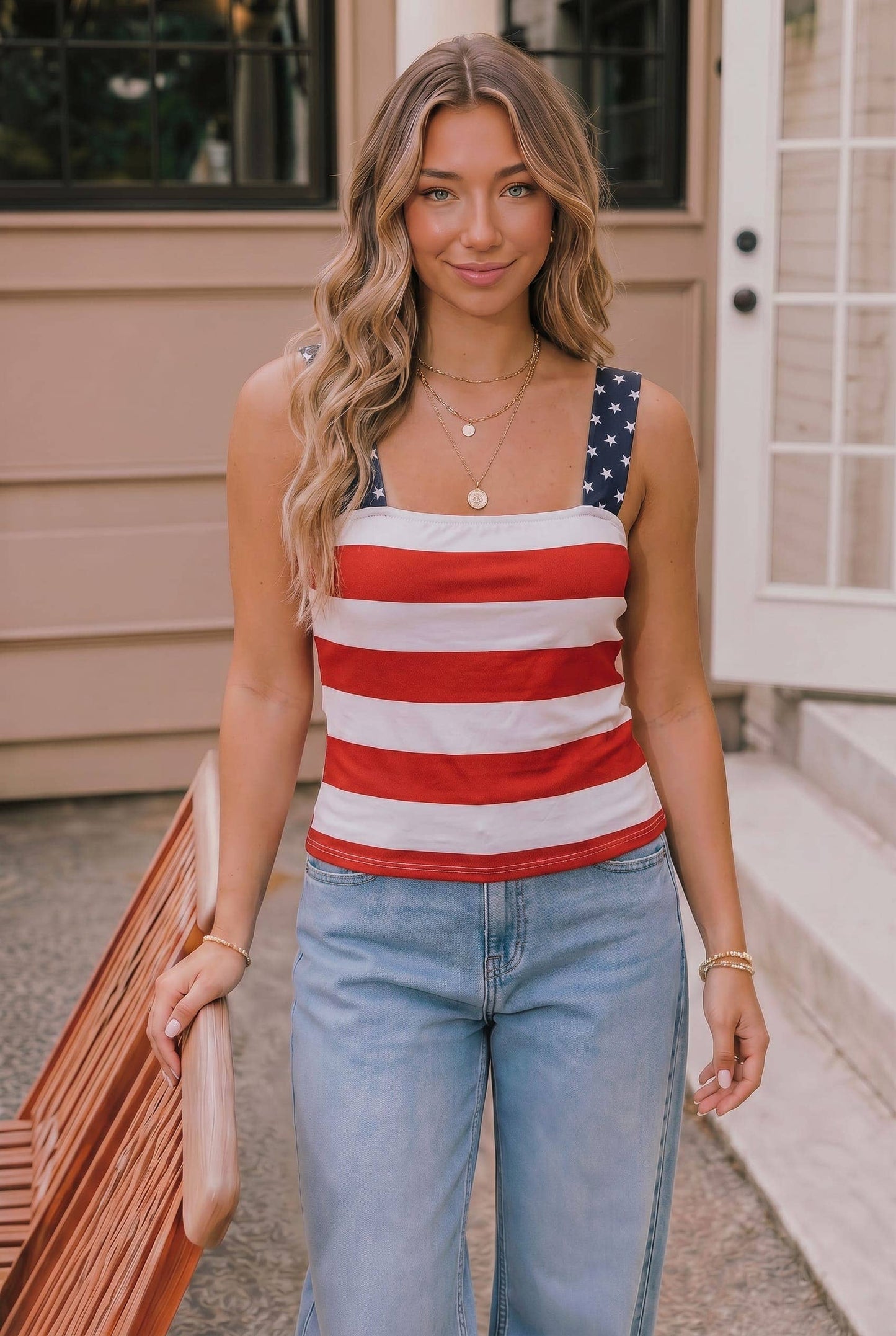 Woman wearing a red, white, and blue striped tank top with an American flag design.