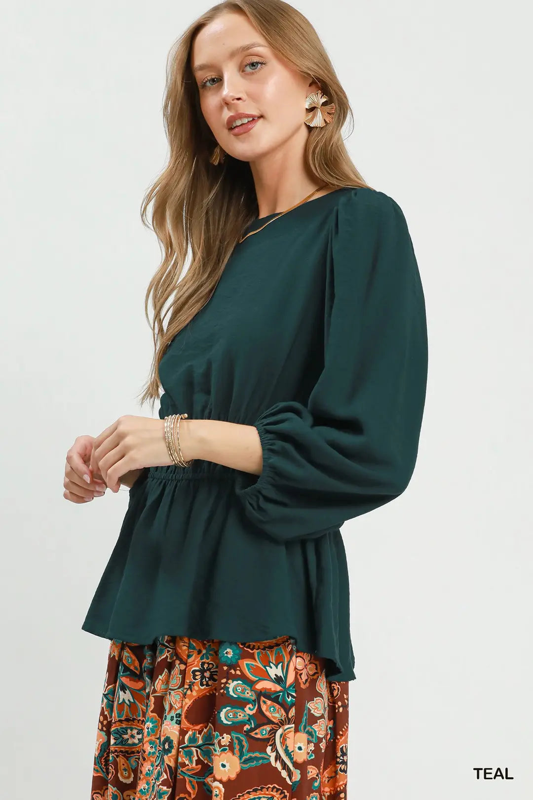 Umgee teal smocked waist peplum blouse styled with jeans