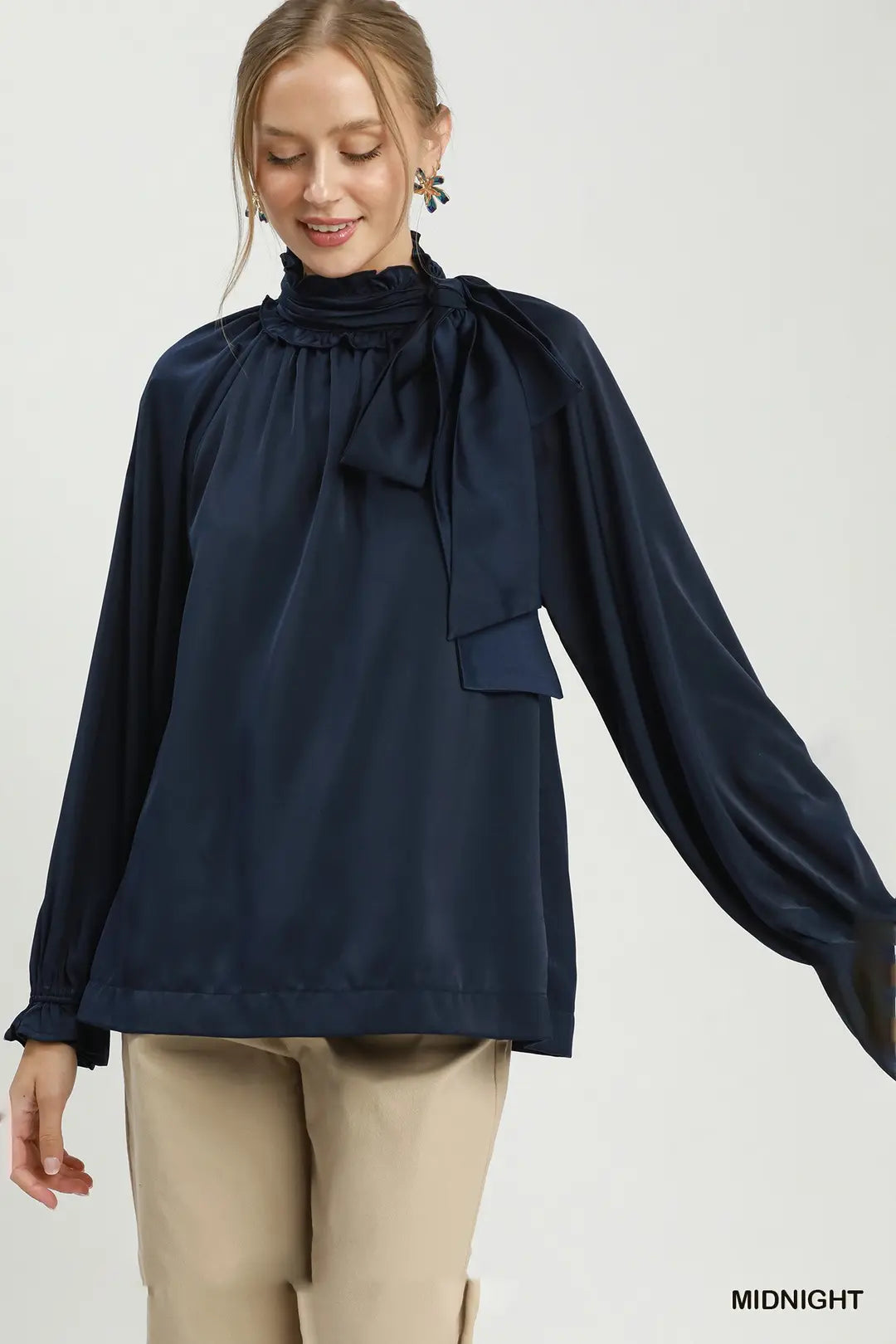 Umgee satin tie-neck ruffle blouse in midnight navy, front view
