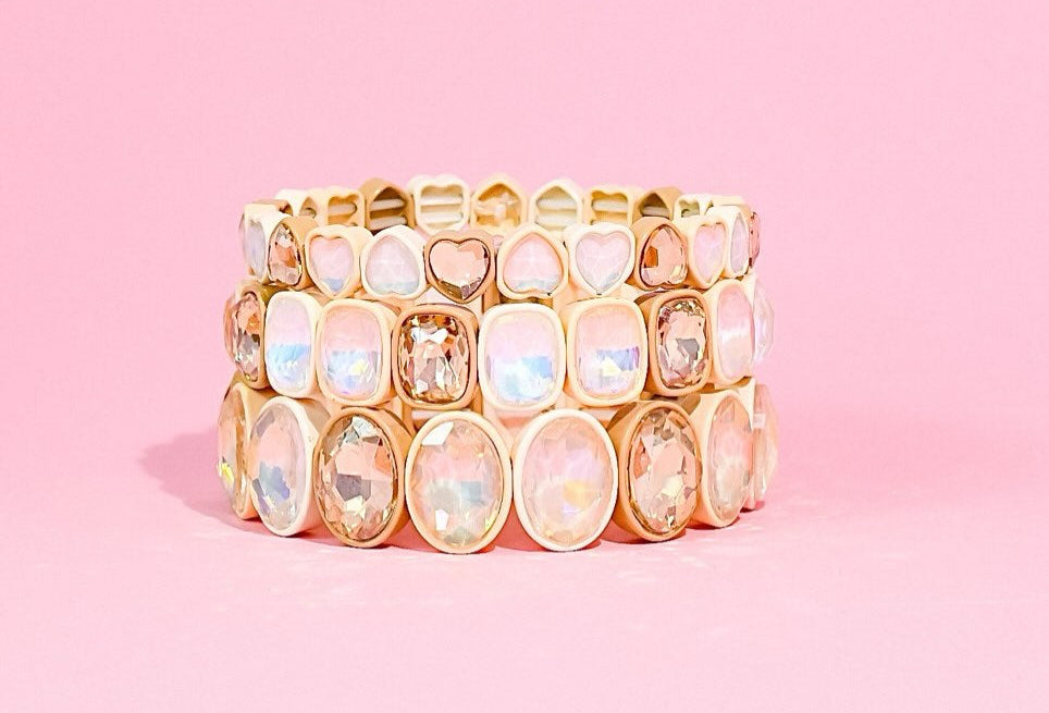 Neutral gold and crystal bracelet stack styled for spring and summer fashion