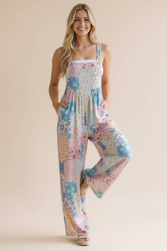Woman wearing a patchwork print jumpsuit on a beige background