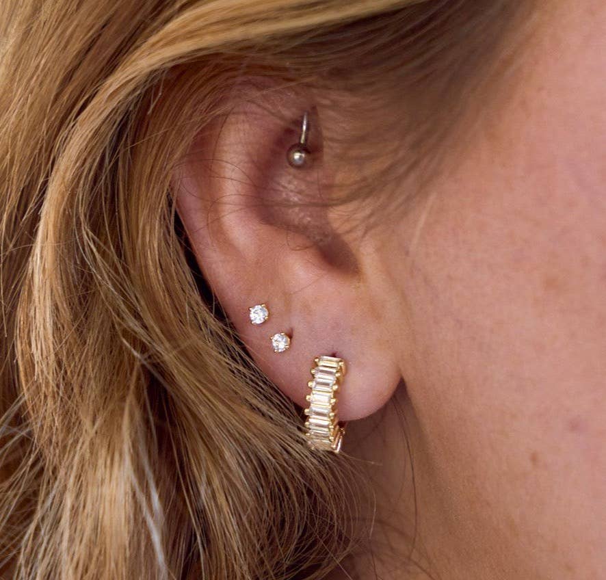 close up of gold and diamond earrings
