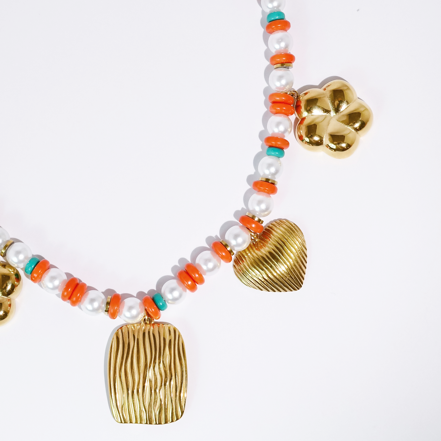 Necklace with gold pendants and colorful beads on a white background
