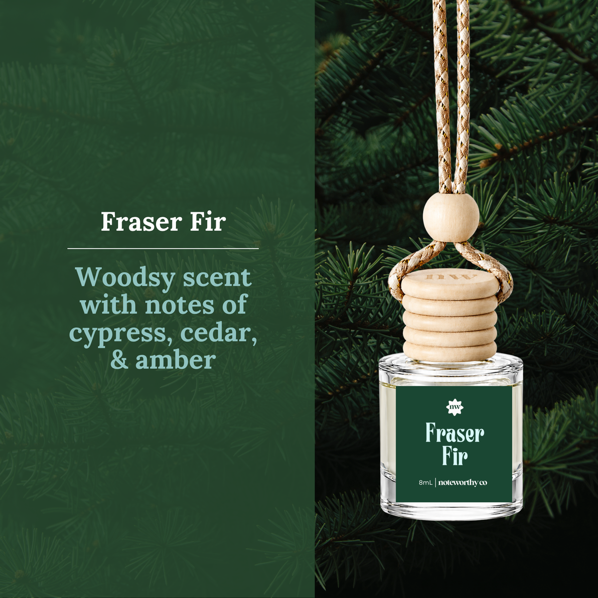 A Fraser Fir reed diffuser bottle with a wooden cap and hanging cord, shown hanging against evergreen branches. The left side has a dark green panel with text reading 'Fraser Fir' and 'Woodsy scent with notes of cypress, cedar, & amber'.