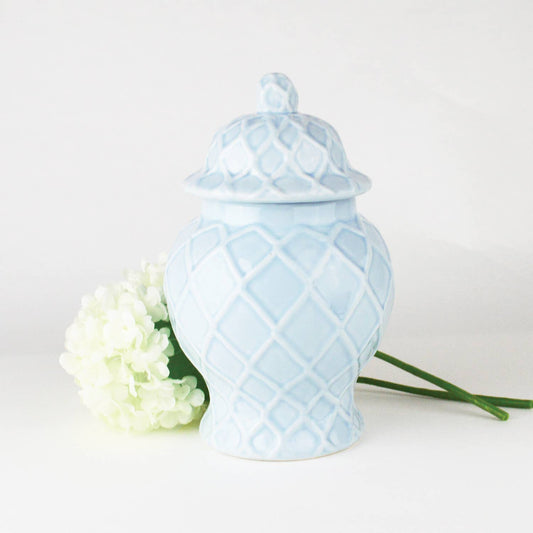 light blue textured ceramic ginger jar with lid styled with hydrangea flowers