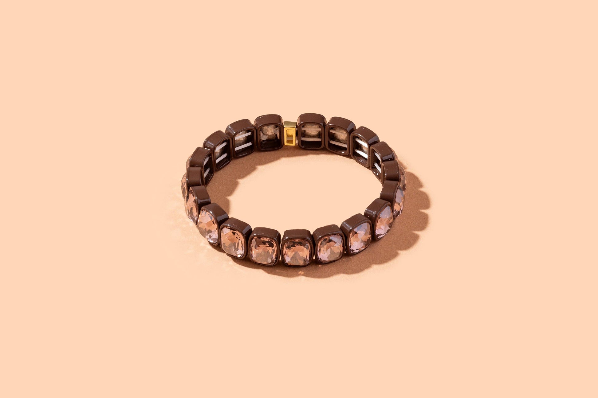 Bracelet with brown beads on a beige background
