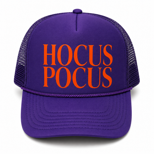 A purple trucker hat with orange text reading 'HOCUS POCUS' on the front, shown against a plain white background.