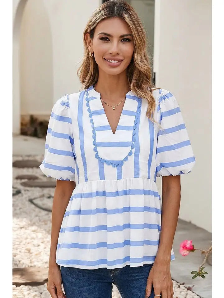 Front view of feminine sky blue striped boutique blouse with puff sleeves and relaxed fit