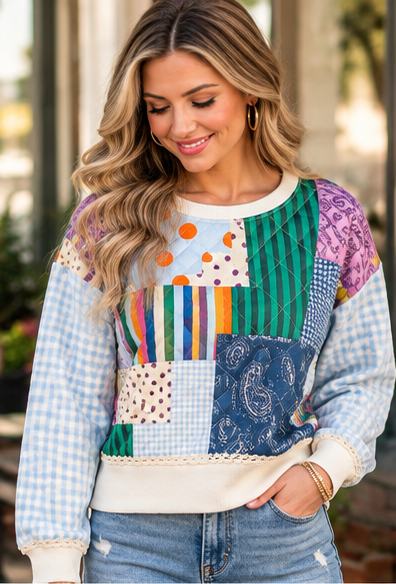 a model wearing a patchwork poppy & pine sweatshirt