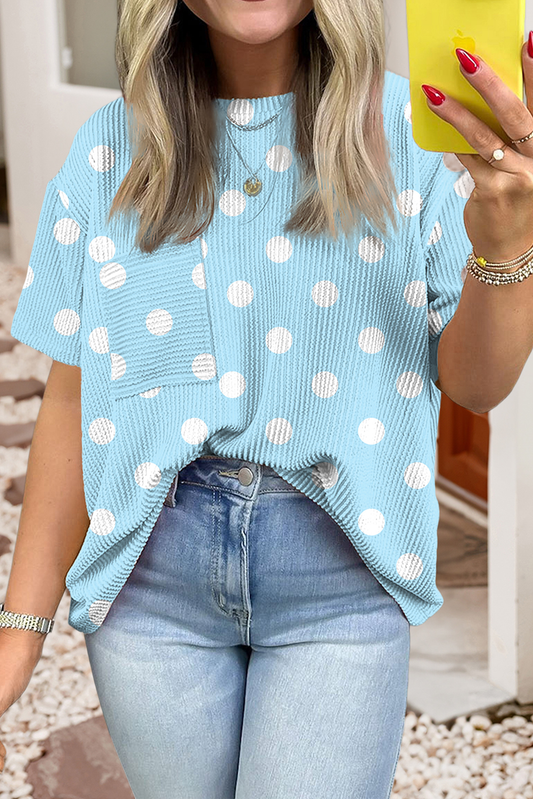 Woman wearing light blue polka dot pocket tee with casual denim outfit