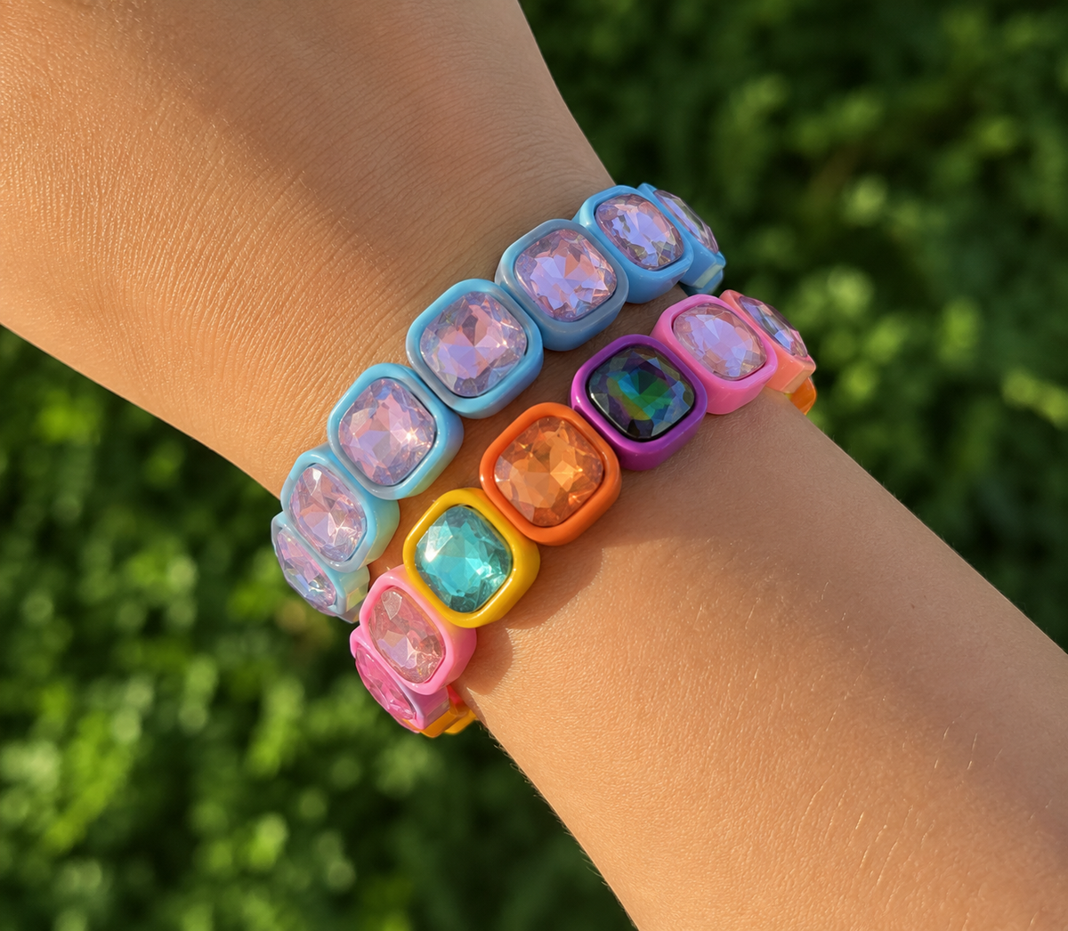 Colorful beaded bracelets on a wrist with a blurred green background