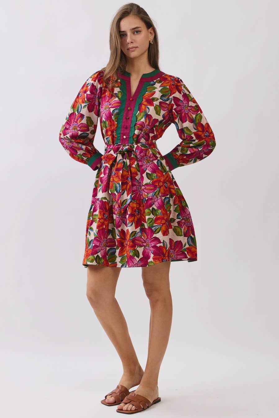 Woman wearing a colorful floral dress on a white background