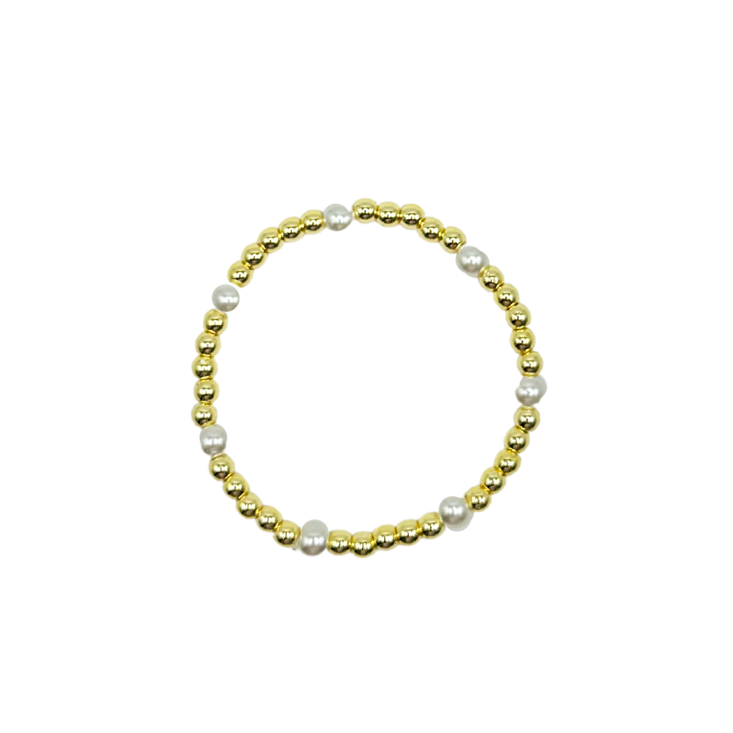 Bracelet with gold beads and pearls on a white background