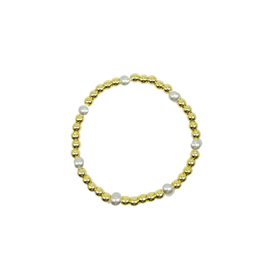 Bracelet with gold beads and pearls on a white background