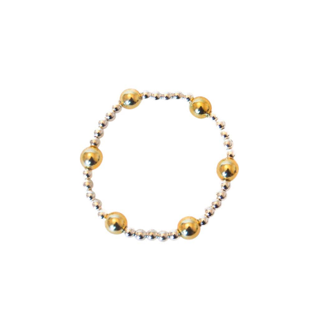 Gold and silver beaded bracelet on a white background