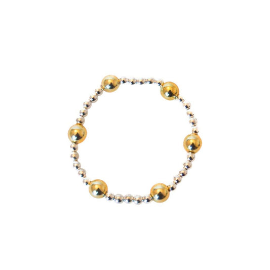 Gold and silver beaded bracelet on a white background