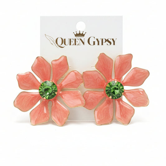 Floral earring with green gemstone on a 'Queen Gypsy' card, held by a hand.