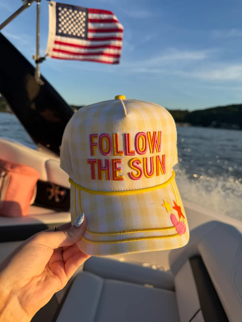 Women's Follow the Sun yellow gingham trucker hat with colorful embroidered lettering, mesh back, adjustable snapback, and "Look on the Bright Side" embroidery on the back.