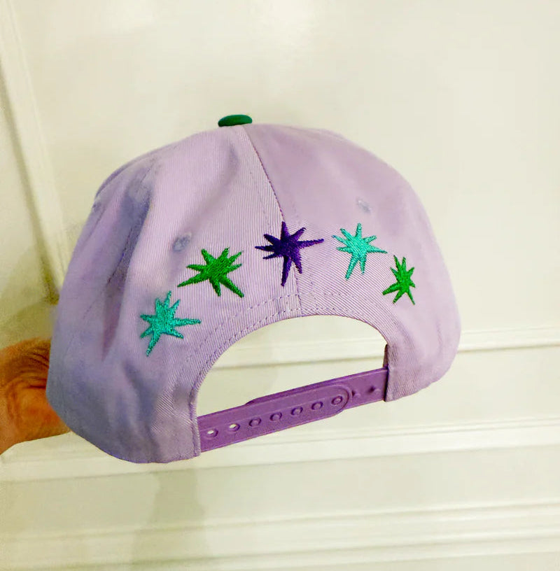 Purple cap with star designs on a light background
