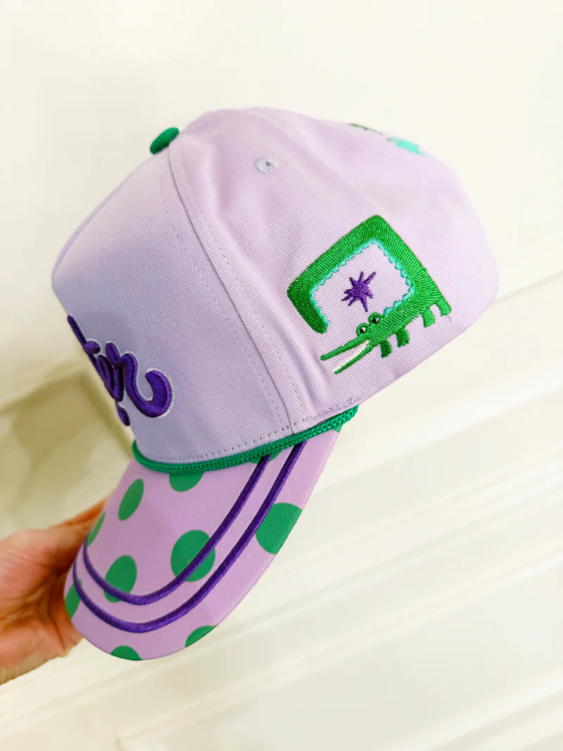 Purple cap with green accents and a logo on a white background