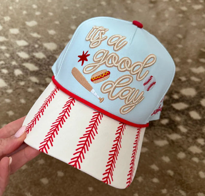 Hand holding a small ice cream cone-shaped container with 'It's a good day' text on a textured surface.