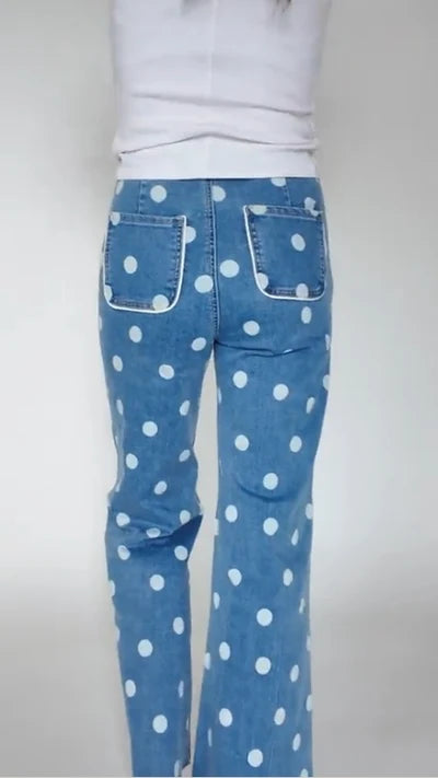 a model wearing denim and white polka dot jeans showing the backside of them.