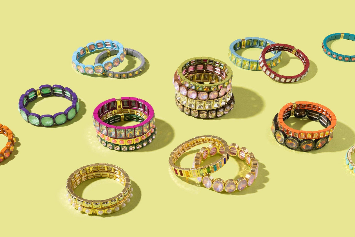 Colorful bracelets arranged on a yellow background
