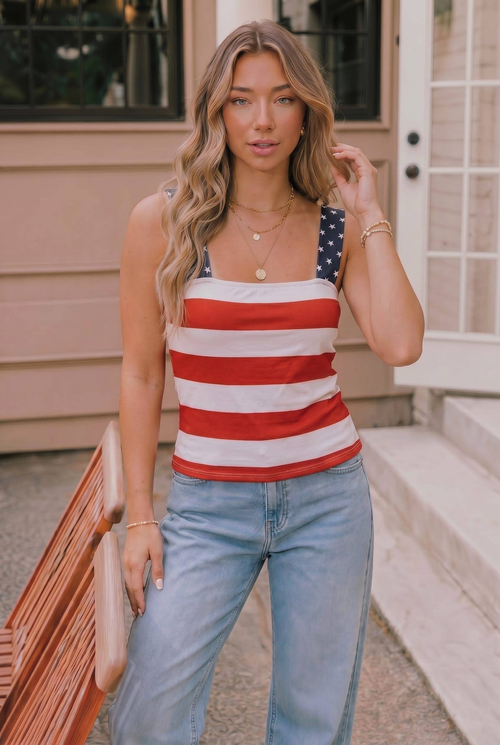 Woman wearing a red, white, and blue striped tank top with an American flag design.