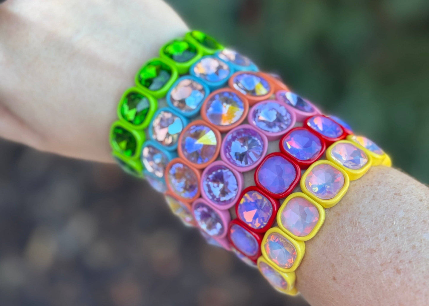Colorful bracelet with a pattern of interlocking circles worn on a wrist.