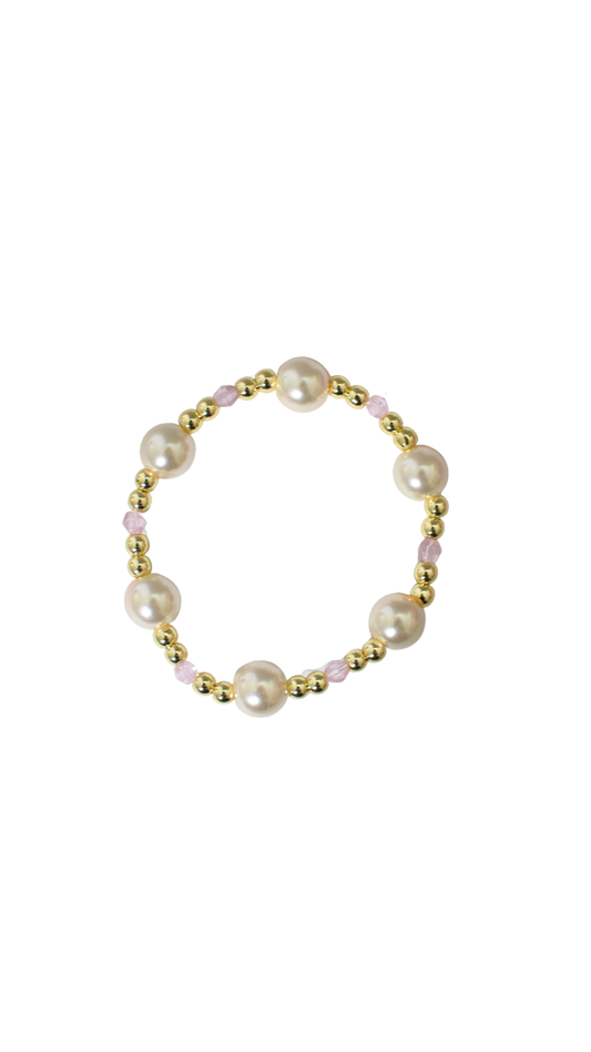 Pearl bracelet with gold accents on a white background