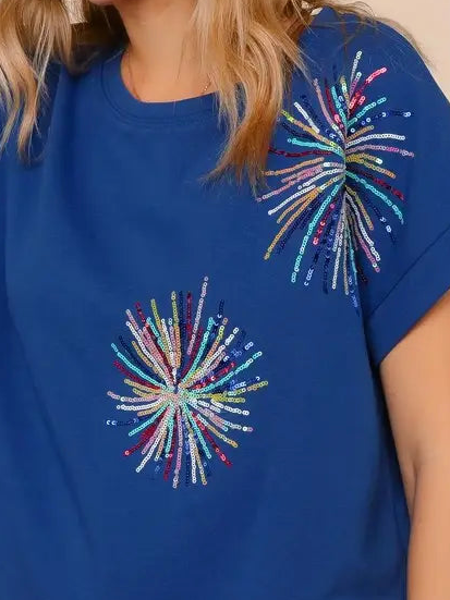 Blue t-shirt with colorful bead embellishments on a person wearing it.