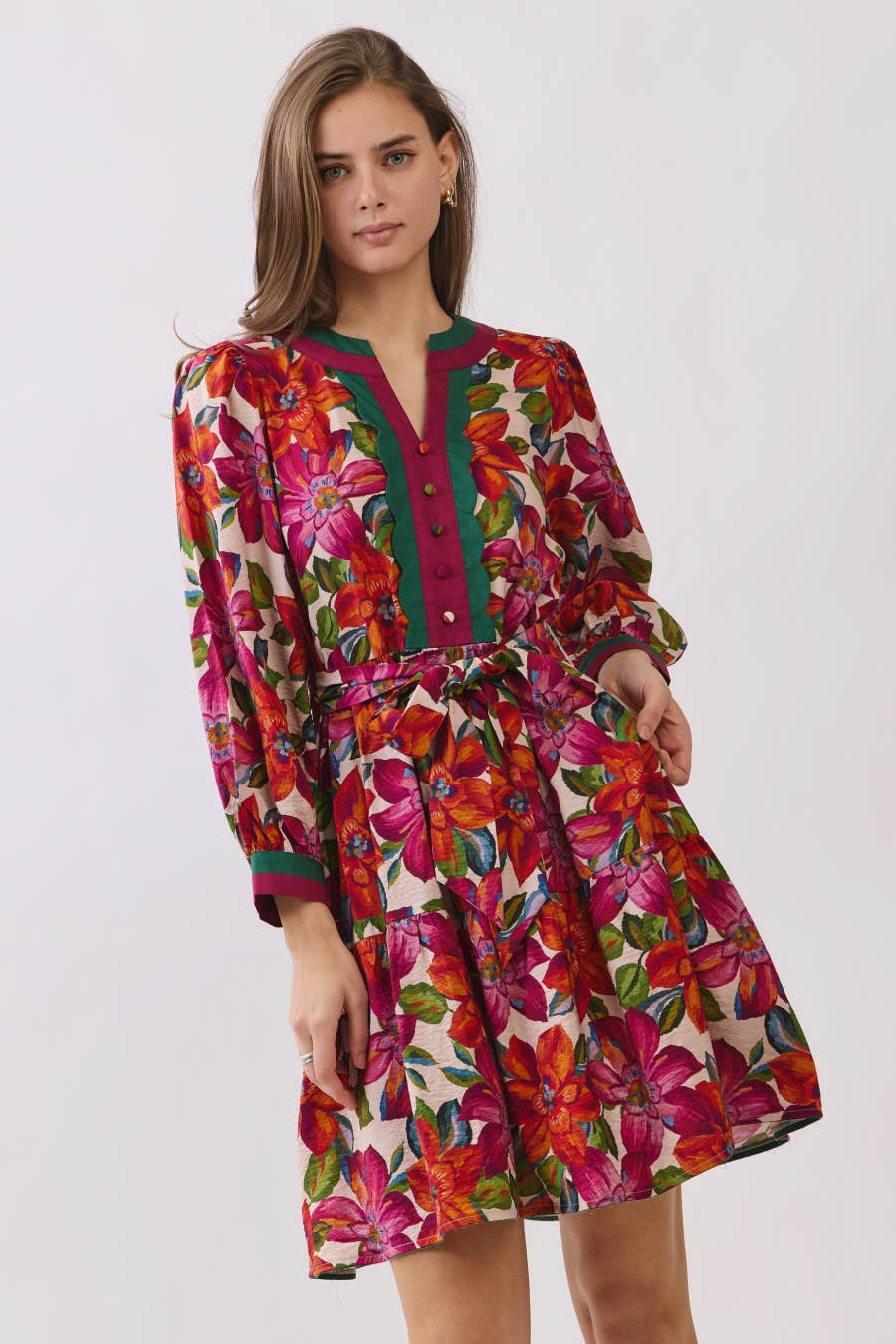 Woman wearing a colorful floral dress on a white background