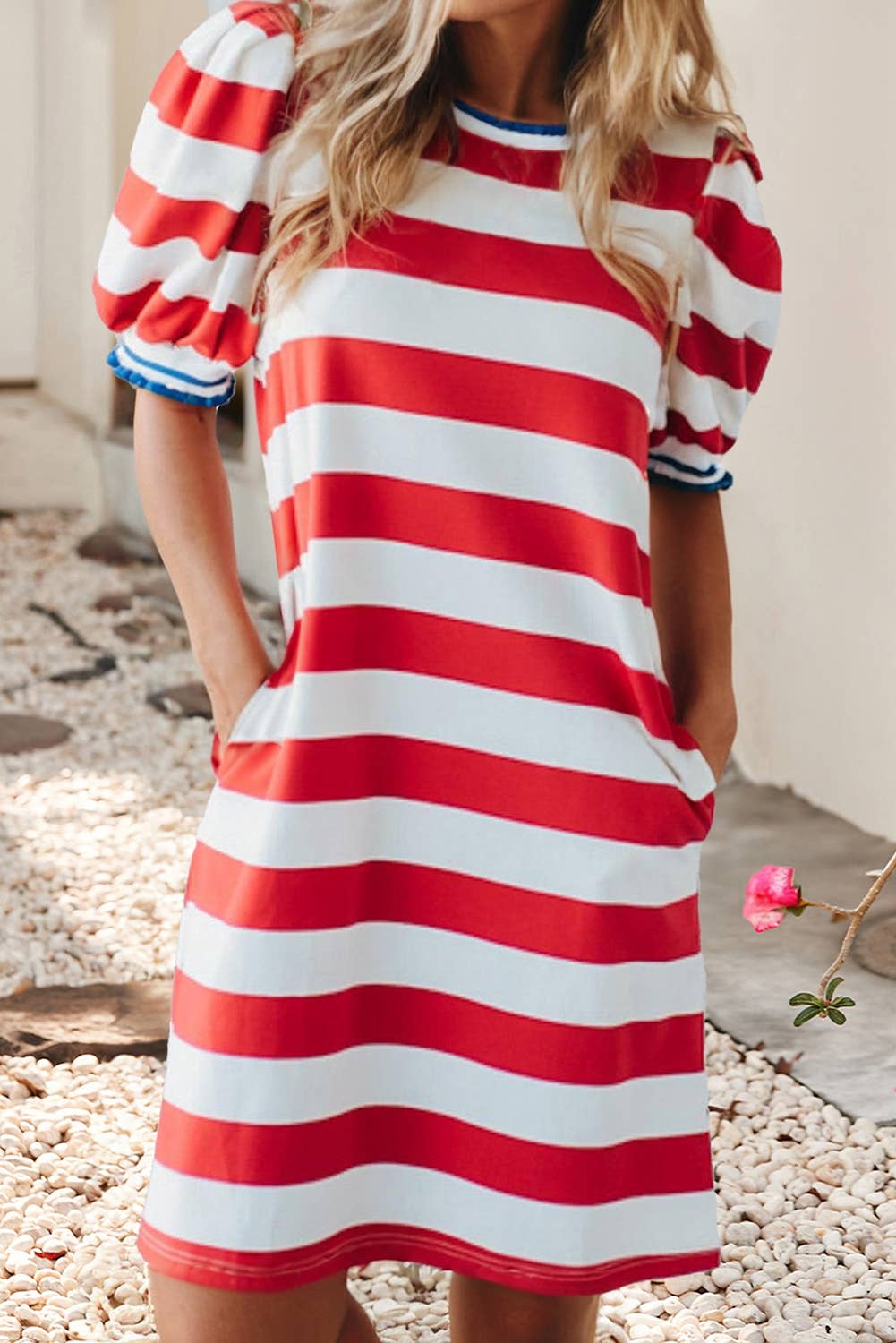 Woman wearing a red and white striped dress with a blurred background