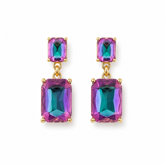 A pair of gold drop earrings featuring rectangular iridescent gemstones that shift between pink, purple, and teal, set against a plain white background.